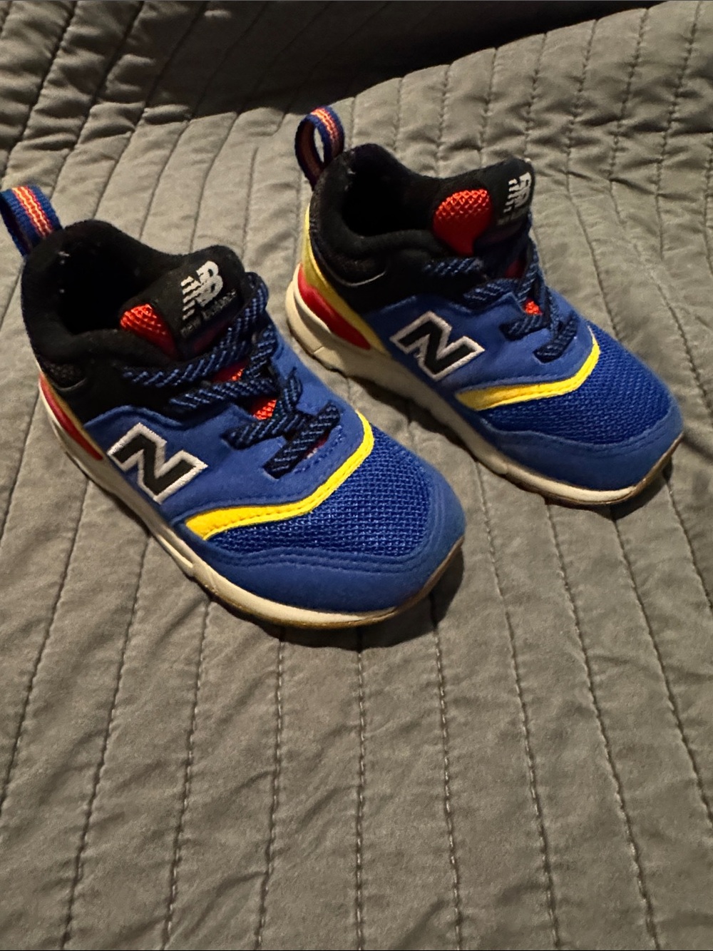 New Balance Kids Blue Sneakers with Yellow and Red Accents